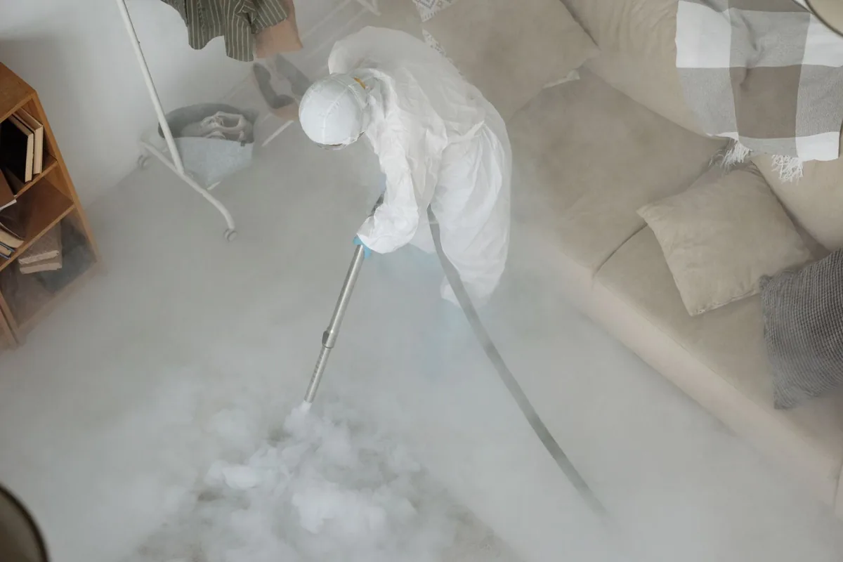 Biohazard cleanup technician in protective equipment, Newark, AR